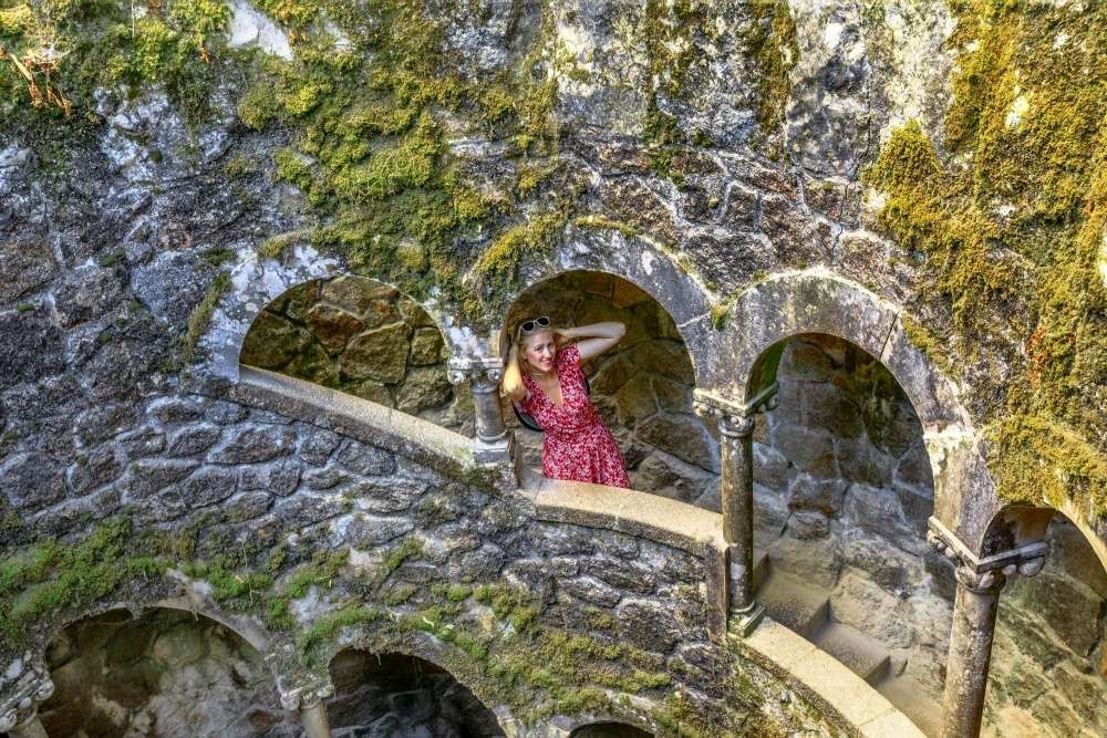Girl inside the Initiatic Well at Quinta da Regaleira in Sintra, Portugal